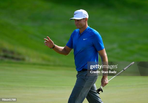 Nick Watney acknowledges the gallery on the 16th hole during the first round of the Quicken Loans National at TPC Potomac at Avenel Farm on June 28,...