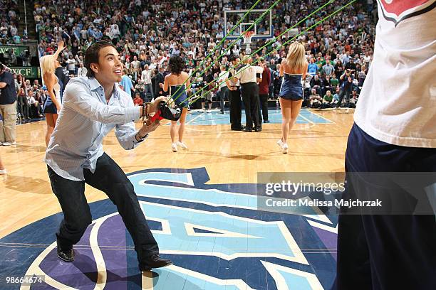 Apolo Ohno eight time Winter Olympic medalist throws out balls during timeout of the Utah Jazz game against the Denver Nuggets in Game Four of the...
