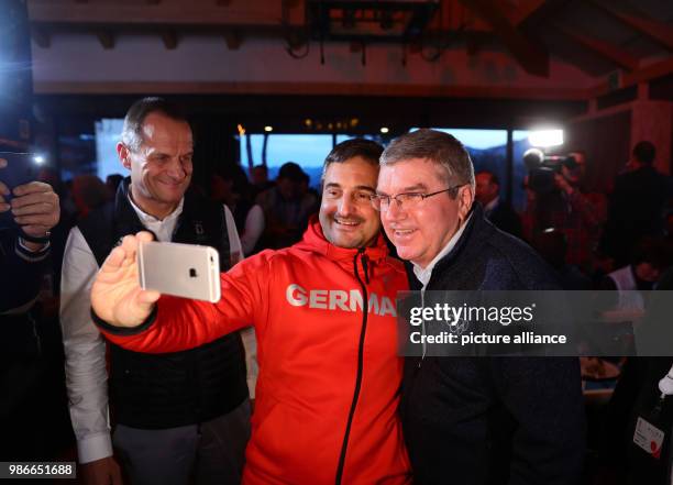 President Thomas Bach being greeeted by Alfons Hoermann , president of the German Olympic Sports Confederation , and luge olympic champion Georg...