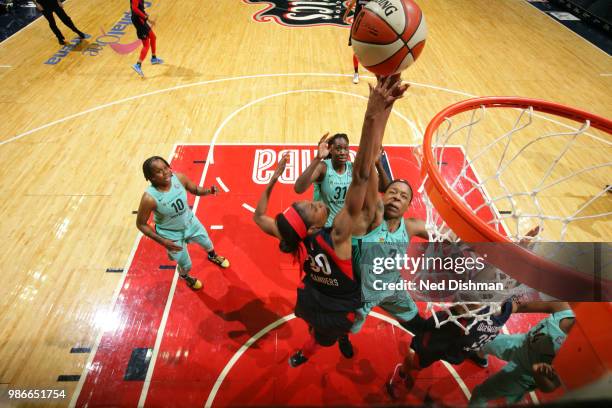 LaToya Sanders of the Washington Mystics and Kia Vaughn of the New York Liberty reach for the rebound on June 28, 2018 at Capital One Arena in...