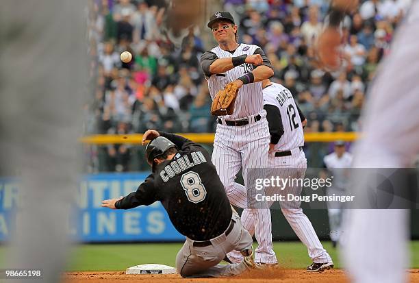 Shortstop Troy Tulowitzki of the Colorado Rockies turns a double play on Chris Coghlin of the Florida Marlins on a grounder hit by Gaby Sanchez to...