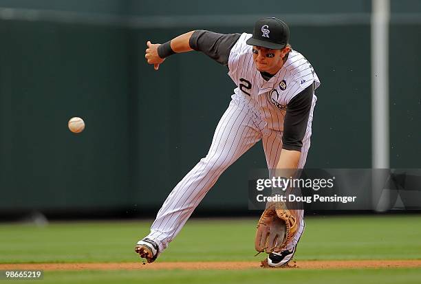 Shortstop Troy Tulowitzki of the Colorado Rockies plays defense, fields a ground ball and throws out Gaby Sanchez of the Florida Marlins at Coors...