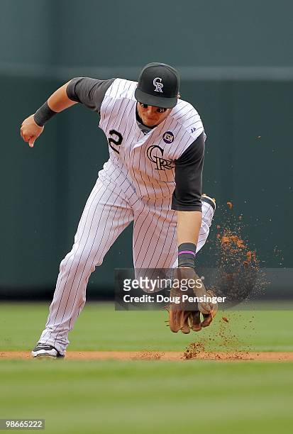 Shortstop Troy Tulowitzki of the Colorado Rockies plays defense, fields a ground ball and throws out Gaby Sanchez of the Florida Marlins at Coors...
