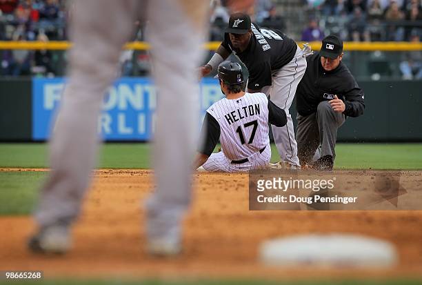 Todd Helton of the Colorado Rockies is tagged out at second base by shortstop Hanely Ramirez of the Florida Marlins as umpire Rob Drake makes the...