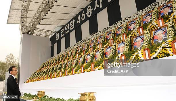 South Korean President Lee Myung-Bak looks at portraits of sailors who were killed in the March 26 sinking of the warship Cheonan at an altar outside...