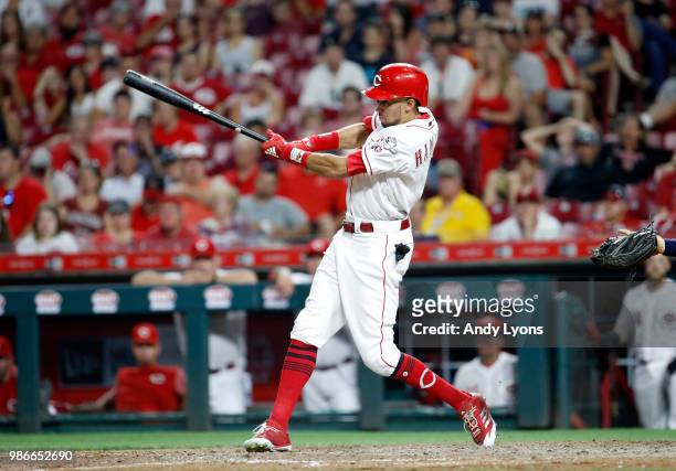 Billy Hamilton of the Cincinnati Reds hits a single in the ninth inning against the Milwaukee Brewers at Great American Ball Park on June 28, 2018 in...