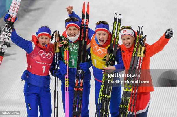 Ingvild Flugstad Oestberg , Astrid Uhrenholdt Jacobsen, Ragnhild Haga and Marit Bjoergen from Norway celebrating their gold medal during the women's...