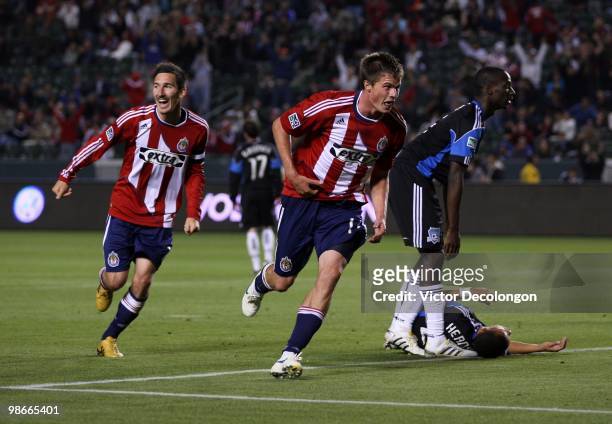 Justin Braun of Chivas USA celebrates after his second half goal followed by teammate Sacha Kljestan as Ike Opara of the San Jose Earthquakes looks...