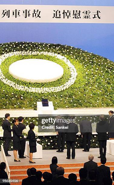 People attend a ceremony to mark the 5th anniversary of the train derailment which killed 107 people in 2005, on April 25, 2010 in Amagasaki, Hyogo,...