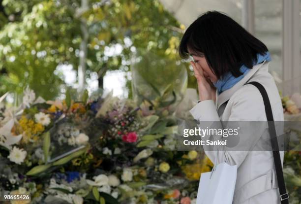 Women sheds tears in front of offered flowers during a ceremony to mark the 5th anniversary of the train derailment which killed 107 people in 2005,...