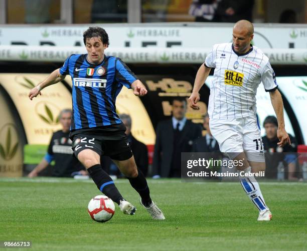 Diego Milito of FC Internazionale Milano battles for the ball against Daniele Capelli of Atalanta BC during the Serie A match between FC...