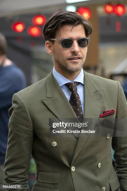 Model Johannes Huebl wears a Marc Anthony suit, Isaia tie during London Fashion Week Men's January 2018 at on June 9, 2018 in London, England.