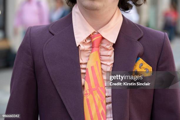 Photographer Harry Bartlett wears a Vivienne Westwood tie, vintage suit, shirt and pocket square during London Fashion Week Men's on June 9, 2018 in...