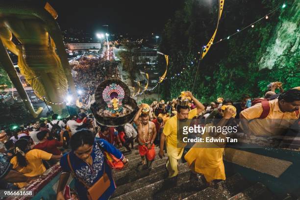 thousand of hindu prayers heading toward batu cave temple during the night of thaipusam in malaysia by climbing the staircase - traditional piercings stock pictures, royalty-free photos & images