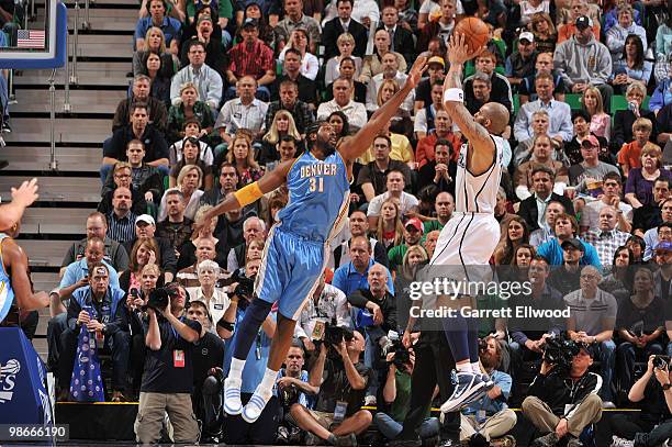 Carlos Boozer of the Utah Jazz shoots over Nene of the Denver Nuggets in Game Four of the Western Conference Quarterfinals during the 2010 NBA...