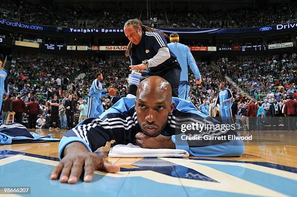 Strength and conditioning coach Steve Hess stretches out Chauncey Billups of the Denver Nuggets prior to the game against the Utah Jazz in Game Four...