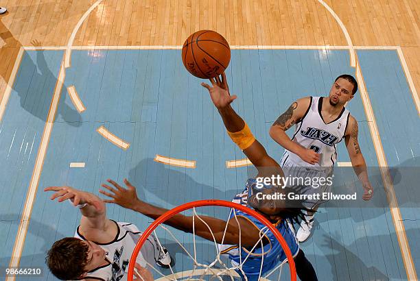 Nene of the Denver Nuggets shoots over Kyrylo Fesenko and Deron Williams of the Utah Jazz in Game Four of the Western Conference Quarterfinals during...