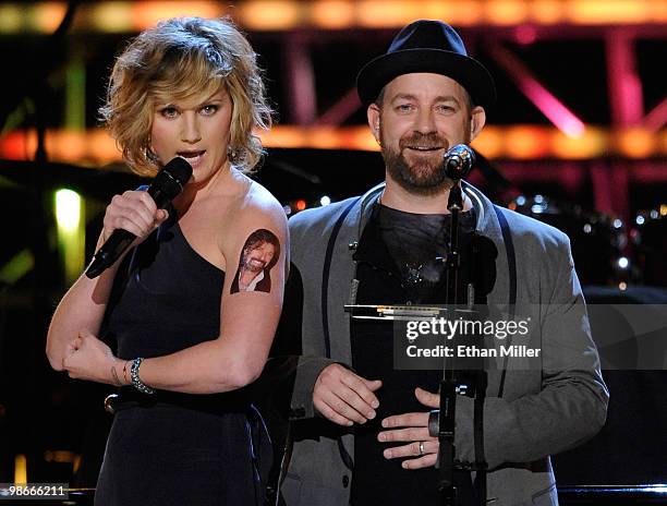 Jennifer Nettles and Kristian Bush of the band Sugarland speak as Nettles shows off a temporary Ronnie Dunn tattoo on her arm during the "Brooks &...