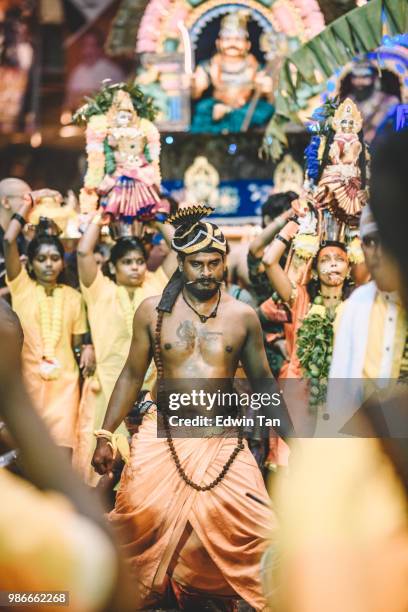 a male indian prayer pierced and walk his way up to the batu cave indian temple at the night of thaipusam in malaysia - traditional piercings stock pictures, royalty-free photos & images