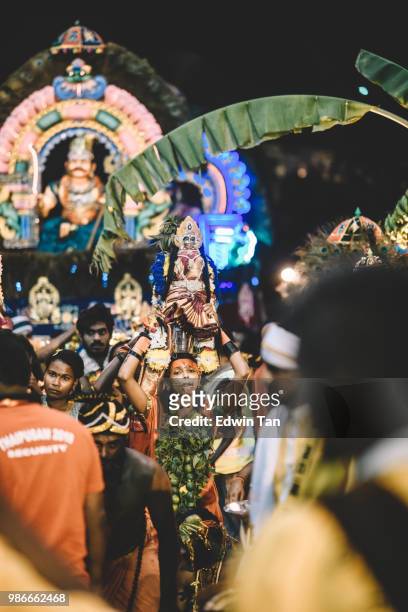 a female indian prayer pierced and walk her way up to the batu cave indian temple at the night of thaipusam in malaysia - traditional piercings stock pictures, royalty-free photos & images