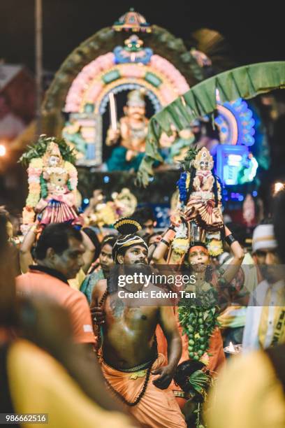 a male indian prayer pierced and walk his way up to the batu cave indian temple at the night of thaipusam in malaysia - traditional piercings stock pictures, royalty-free photos & images