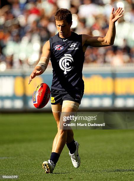 Marc Murphy of the Blues kicks to a teammate during the round five AFL match between the Carlton Blues and the Geelong Cats at Melbourne Cricket...