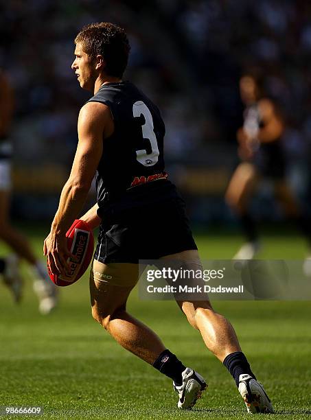 Marc Murphy of the Blues kicks to a teammate during the round five AFL match between the Carlton Blues and the Geelong Cats at Melbourne Cricket...