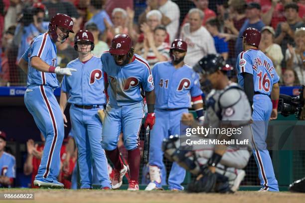 Rhys Hoskins of the Philadelphia Phillies celebrates with Odubel Herrera, Carlos Santana, and Cesar Hernandez after hitting a two run home run in the...