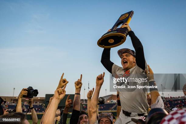 Oregon State's Kevin Abel holding the National Champion trophy pitched a complete game against Arkansas during the third game of the finals in the...