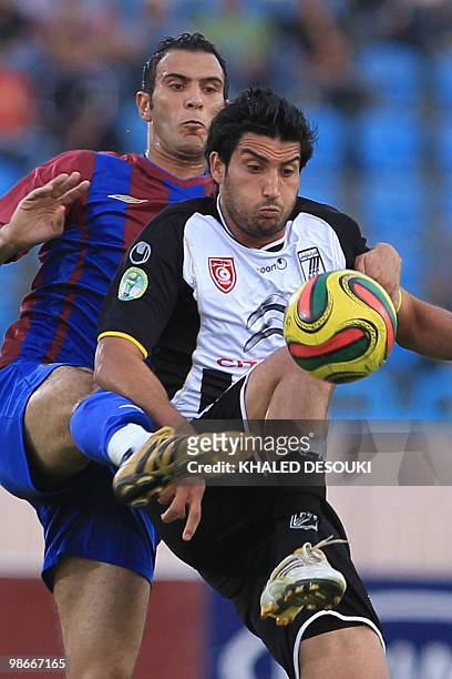 Egypt's Petrojet club player Karim Zekri fights for the ball with Hamza Younes of Tunisia�s CS Sfaxien football team during their African Champions...