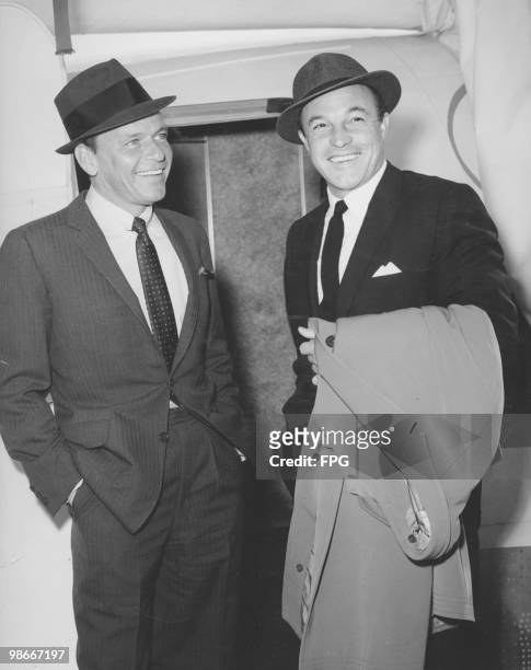 American singer and actor Frank Sinatra with American dancer and actor Gene Kelly at John F. Kennedy International Airport, New York, 16th October...