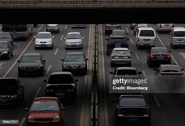Traffic moves along a street in Beijing, China, on Sunday, April 25, 2010. China's economic growth accelerated to the fastest pace in almost three...