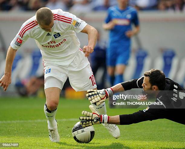 Hamburg's Croatian striker Mladen Petric is stopped by Hoffenheim's goalkeeper Daniel Haas during the German first division Bundesliga football match...