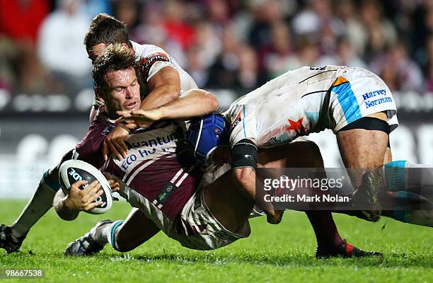 Josh Perry of the Eagles is tackled during the round seven NRL match between the Manly Sea Eagles and the Gold Coast Titans at Brookvale Oval on...