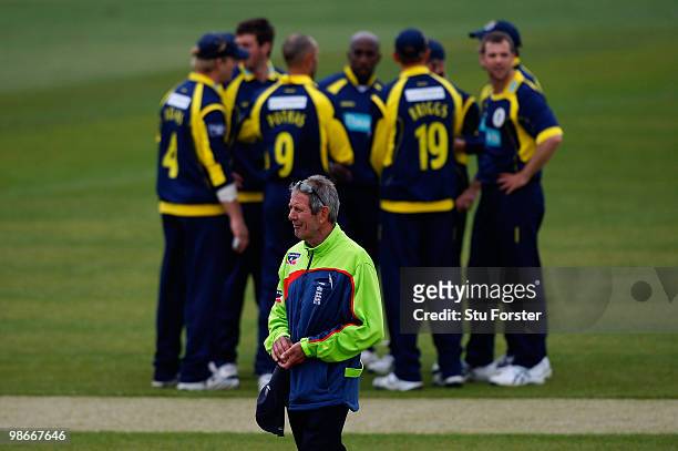 Umpire Steve Malone looks on as the Hampshire team huddle during the Clydesdale Bank 40 match between Durham Dynamos and Hampshire Royals at The...