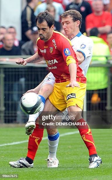 Lens's Portuguese defender Marco Ramos vies with Valenciennes's French defender David Ducourtioux during the French L1 football match Lens vs....