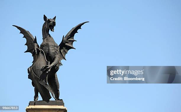 Statue of a Griffin carrying the coat of arms of the City of London stands on a pedestal in London, U.K., on Friday, April 23, 2010. The City marks...