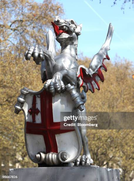Statue of a Griffin carrying the coat of arms of the City of London stands on a pedestal in London, U.K., on Friday, April 23, 2010. The City marks...