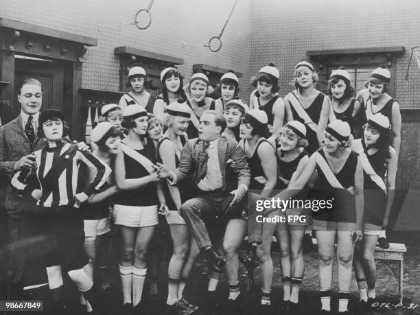 American comic actor, Roscoe 'Fatty' Arbuckle and a group of Sennett Bathing Beauties in a publicity shot for a Mack Sennet silent comedy film, USA,...