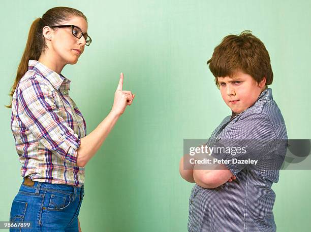 teacher telling off overweight school boy - anti social beahviour stock pictures, royalty-free photos & images