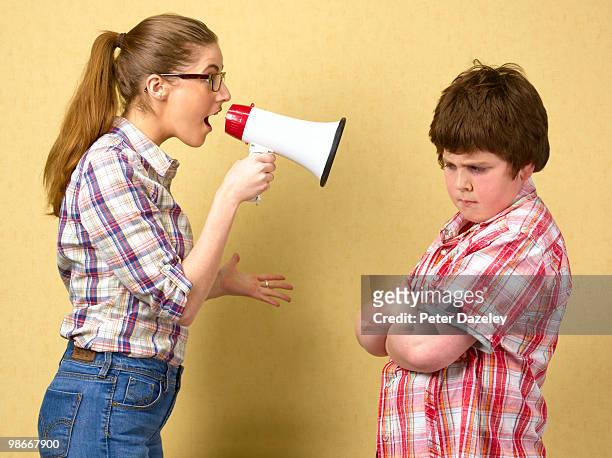 sister shouting at brother with megaphone - annoying brother stock pictures, royalty-free photos & images
