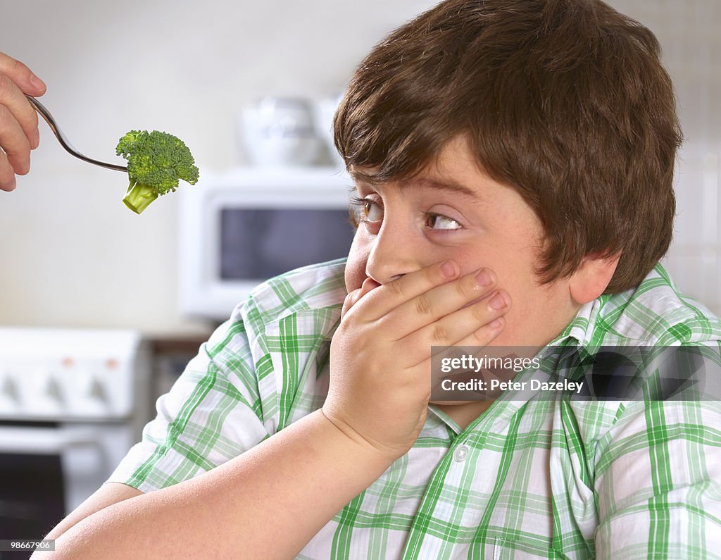 Overweight boy hates broccoli