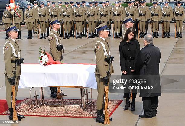 Soldiers stand on April 13, 2010 next to the coffin of Polish First Lady Maria Kaczynska at Warsaw's airport on April 13, 2010 as her daughter Marta...