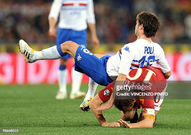 Roma's forward Francesco Totti crashes after jumping for the ball with Sampdoria's midfielder Andrea Poli during their Serie A football match at...