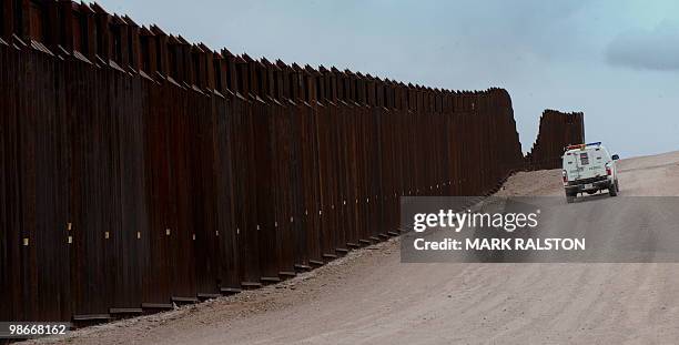 Border Patrol vehicle drives along the fence seperating the US from Mexico near the town of Nogales, Arizona on April 23, 2010. Two Republican...