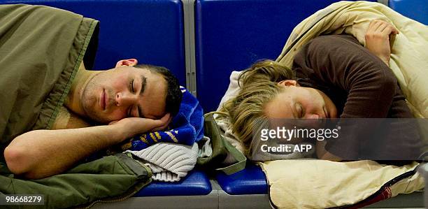Couple sleep on seats at Gatwick airport in southern England, on April 19 following the closure of the airport due to volcanic ash emitted from an...