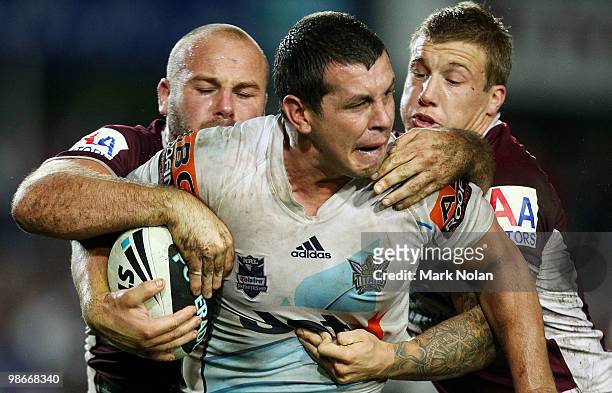 Greg Bird of the Titans is tackled during the round seven NRL match between the Manly Sea Eagles and the Gold Coast Titans at Brookvale Oval on April...