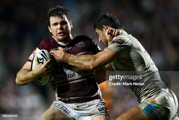 Jamie Lyon of the Eagles is tackled by Mark Minichiello of the Titans during the round seven NRL match between the Manly Sea Eagles and the Gold...