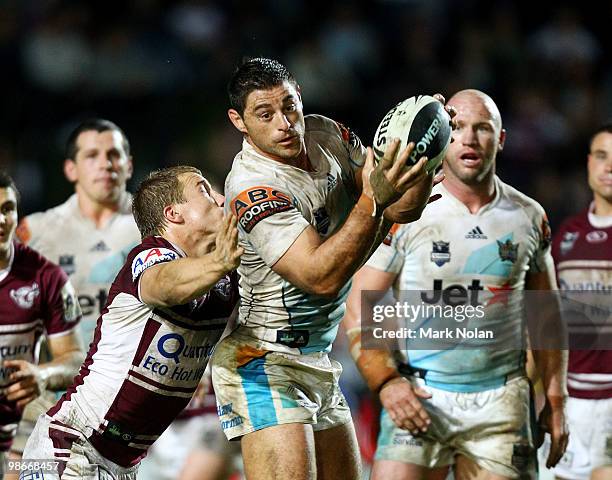 Mark Minichiello of the Titans is tackled during the round seven NRL match between the Manly Sea Eagles and the Gold Coast Titans at Brookvale Oval...