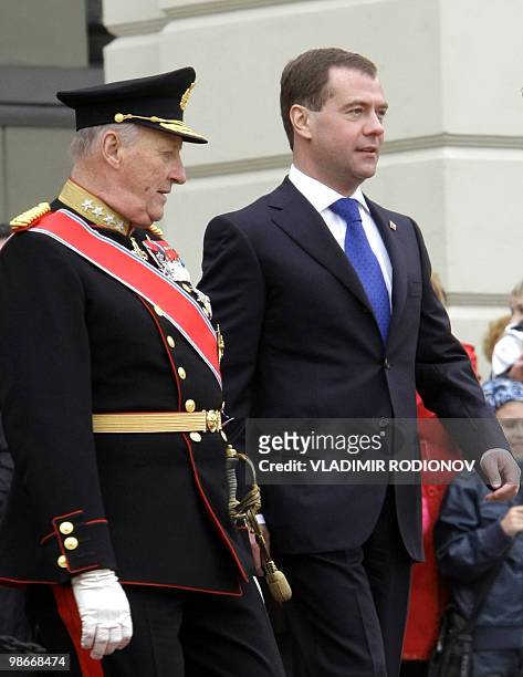 Russian President Dmitry Medvedev walks with Norwegian King Harald outside the Norwegian Royal Palace in Oslo on April 26, 2010. Medvedev arrived in...